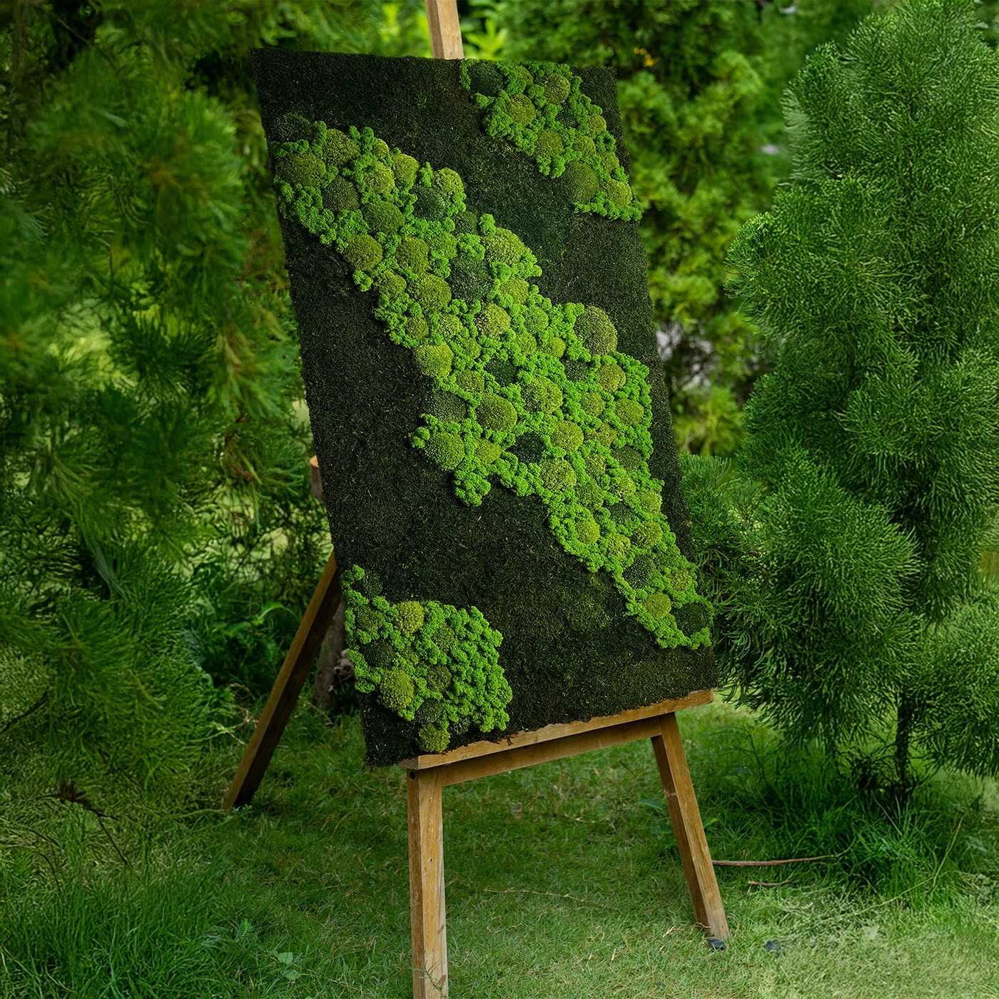 A panel of stabilized moss on an easel in the garden
